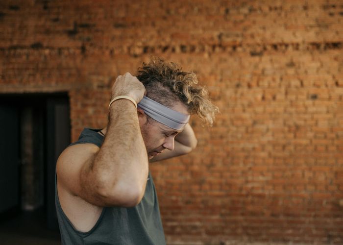Side profile of a person concentrating during a gentle exercise.